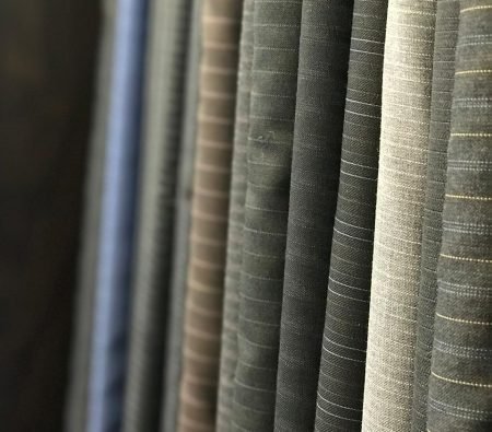 Premium Drapers Golden Selection fabric swatches for bespoke suit tailoring at The White Stripes Tailors and Shirtmakers Dubai